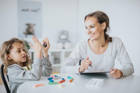 Occupational Therapist working with child on emotional regulation at a table.